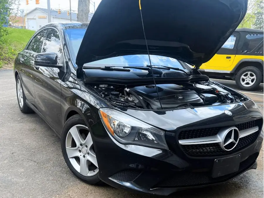 A car in for service with the hood up at CPR 4 Your Car in North Canton